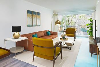 A living room with a yellow chair and a white table.