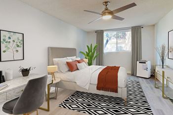 A modern bedroom with a large bed and a ceiling fan.