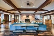 Culver City apartment for rent - A large blue couch sits in the middle of a spacious room with a brick fireplace at The Meadows Apartments, Culver City , CA 90230