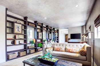 A living room with a couch and a bookshelf