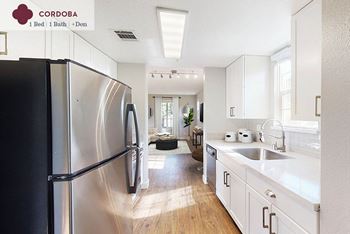 A kitchen with a stainless steel refrigerator and a sink