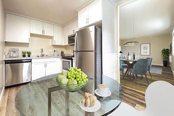 A kitchen with stainless steel appliances and a glass table