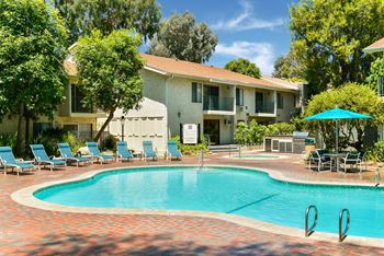 A swimming pool with a house in the background