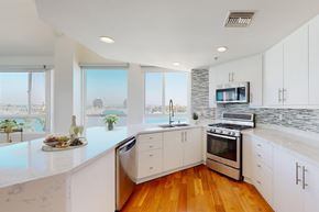 Marina Del Rey apartment for rent - A modern kitchen with white cabinets and a marble countertop at Esprit Marina del Rey, 90292