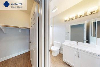 A bathroom with a toilet and a sink and a mirror