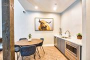 Victorville apartment for rent - A kitchen with a table and chairs and a painting of a bison on the wall at Mountain Vista, Victorville, CA