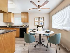 Pleasanton apartment for rent - A kitchen with a table set for two and a ceiling fan at Pleasanton Place, Pleasanton, CA, 94566