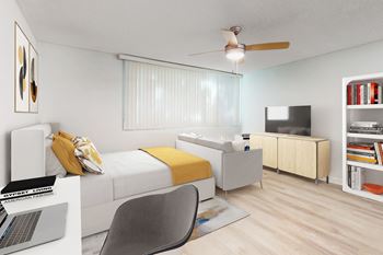 A modern bedroom with a bed, chair, and a laptop.