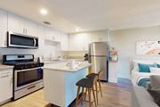 West Hollywood apartment for rent - A kitchen with white cabinets and a blue island at Mediterranean Village West Hollywood, West Hollywood, 90069