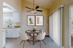 Pleasanton apartment for rent - A dining room with a table set for two and a ceiling fan at Valley Plaza Villages, California, 94566