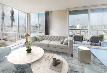 A modern living room with a large window overlooking a marina.