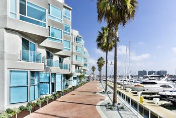 A marina with boats and a building with balconies.