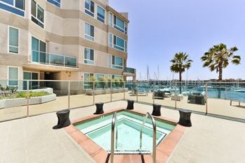 A pool area with a building in the background.