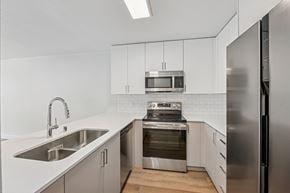 Marina Del Rey apartment for rent - A modern kitchen with stainless steel appliances and white cabinetry.