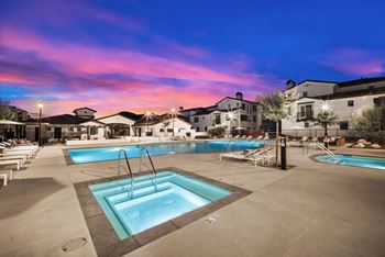 A large outdoor swimming pool with a fountain in the middle.
