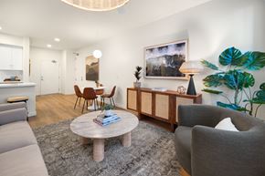 Camarillo townhouse for rent - A living room with a grey couch, a wooden coffee table, and a grey armchair at The Villas at Anacapa Canyon, Camarillo, 93012