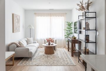 Stamford apartment for rent - A living room with a white sofa, a wooden coffee table, and a rug on the floor.