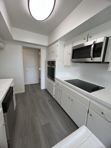Los Angeles apartment for rent - a kitchen with white cabinets and stainless steel appliances