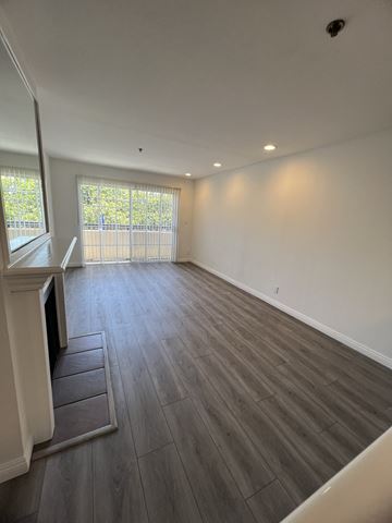 Los Angeles apartment for rent - an empty living room with wooden floors and a window