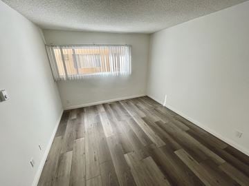 Los Angeles apartment for rent - an empty bedroom with wood flooring and a window