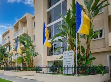 Los Angeles apartment for rent - a building with flags and a sign in front of it