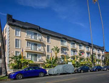 Los Angeles apartment for rent - a large apartment building with cars parked in front of it
