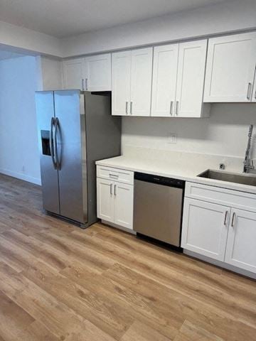 West Hollywood apartment for rent - a kitchen with white cabinets and a stainless steel refrigerator