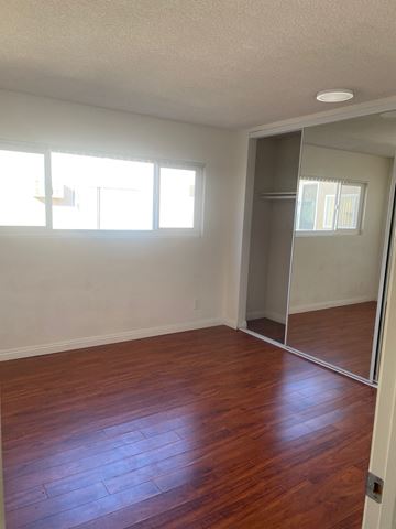 Los Angeles apartment for rent - an empty living room with wood floors and a mirrored closet