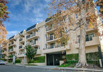 West Hollywood apartment for rent - an apartment building on a street with a tree in front of it