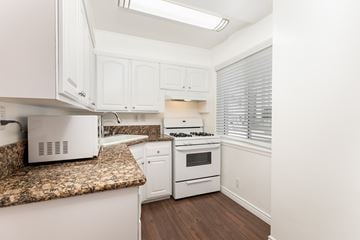 Los Angeles apartment for rent - a kitchen with white appliances and granite counter tops