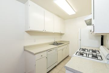 Los Angeles apartment for rent - a kitchen with white cabinets and a stove and a sink