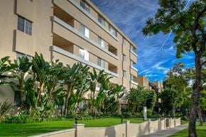 Beverly Hills apartment for rent - an exterior view of a building with grass and trees