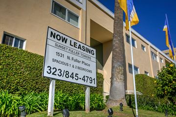 Los Angeles apartment for rent - a now leasing sign in front of an apartment building