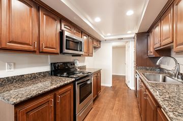 Los Angeles apartment for rent - a kitchen with wood cabinets and granite counter tops and stainless steel appliances