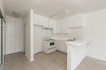 Los Angeles apartment for rent - an empty kitchen with white cabinets and a white counter top