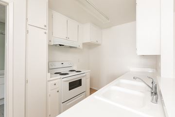 Los Angeles apartment for rent - a kitchen with white appliances and white cabinets and a sink