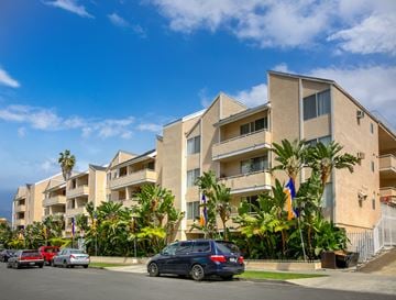 Los Angeles apartment for rent - a row of apartment buildings with cars parked in front of them