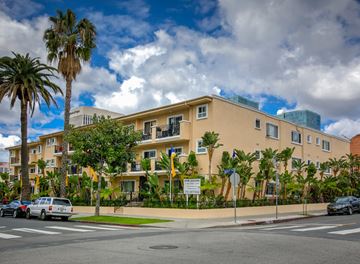 Los Angeles apartment for rent - a building on the corner of a street with palm trees