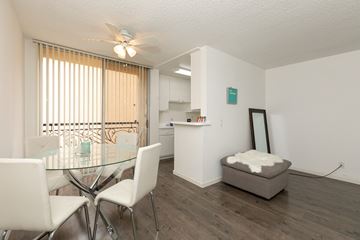 Los Angeles apartment for rent - a dining room and kitchen with a glass table and chairs