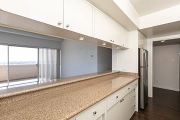 Los Angeles apartment for rent - A kitchen with white cabinets and a granite countertop.