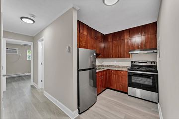 Oak Ridge apartment for rent - A kitchen with wooden cabinets and stainless steel appliances.