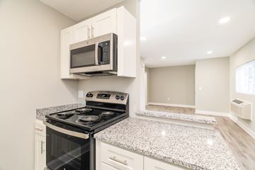 Knoxville apartment for rent - A kitchen with a stove and microwave.