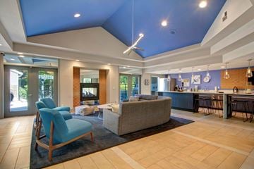 Mukilteo apartment for rent - A living room with a blue chair and a grey couch.