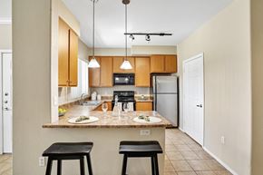 Goodyear apartment for rent - A kitchen with a table and two stools.