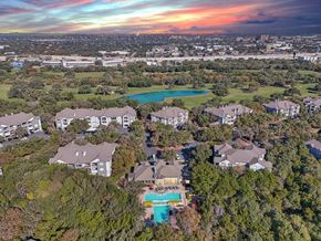 San Antonio apartment for rent - A bird's eye view of a residential area with houses and a swimming pool at Legends on the Green Apartments, San Antonio, TX