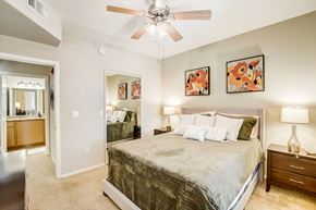 Goodyear apartment for rent - a bedroom with a large bed and a ceiling fan  at Adiamo Palm Valley, Arizona