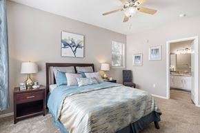 Austin apartment for rent - a bedroom with a bed and a ceiling fan at Sonterra Apartment Homes, Austin