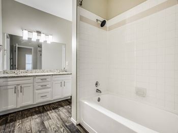 A bathroom with a bathtub and a sink