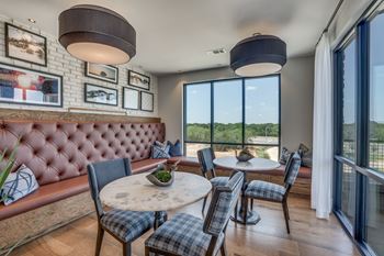 A dining room with a round table and chairs.