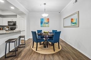 Plano apartment for rent - A dining room with a table set for four.